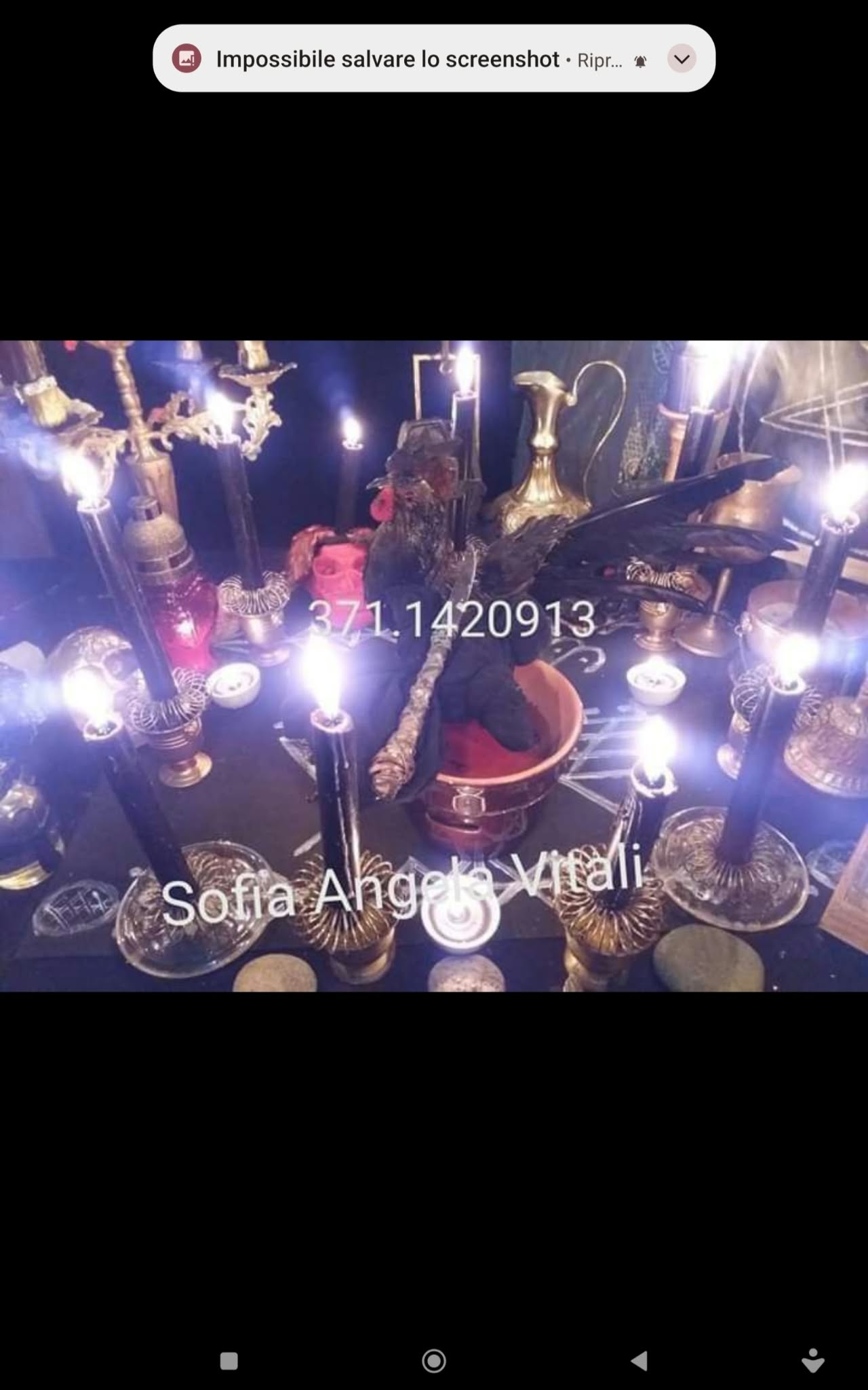 A wide tabletop display with many candles, vessels and decorative objects, photographed from above with strong candle glare.